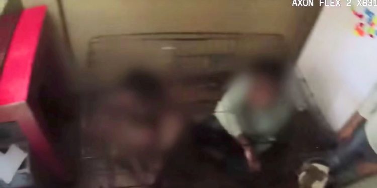 Two children are seen in a dog kennel at their Las Vegas home.
