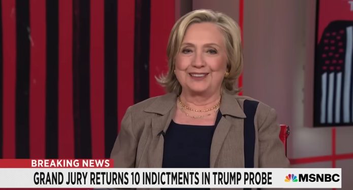 Former Secretary of State Hillary Clinton laughed at the upcoming indictment charges against former President Donald Trump for a fourth time during an interview with Rachel Maddow on MSNBC. (Screenshot/MSNBC/YouTube)