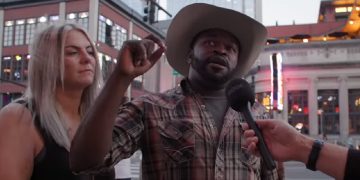 A man interviewed in a cowboy hat on a Nashville street.