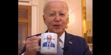 President Joe Biden holds a "Dark Braden" coffee mug in a promo for campaign merchandise.