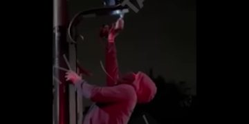 Someone is seen removing an Ultra Low Emission Zone camera.