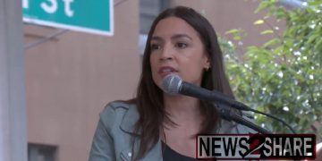 Rep. Alexandria Ocasio-Cortez addresses an environmentalist march in New York on Sunday.