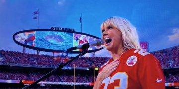 Christian artist Natalie Grant sings the national anthem before the NFL's season opener Thursday at Arrowhead Stadium in Kansas City.