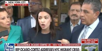 Democratic Rep. Alexandria Ocasio-Cortez of New York tries to speak during a protester-filled media event Friday in New York City.