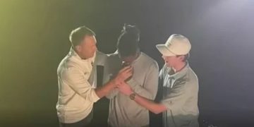 Someone is seen getting baptized at Auburn University.