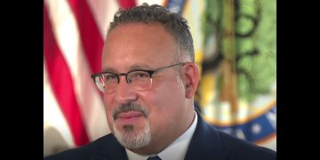 Education Secretary Miguel Cardona speaks to the Associated Press on Friday.