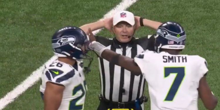 A referee is seen in an exchange with a player on Sunday.