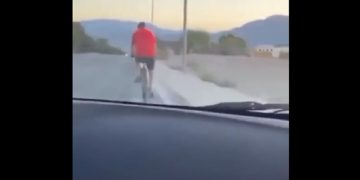 A bicyclist is seen from the vehicle that hit him from behind on Aug. 14.