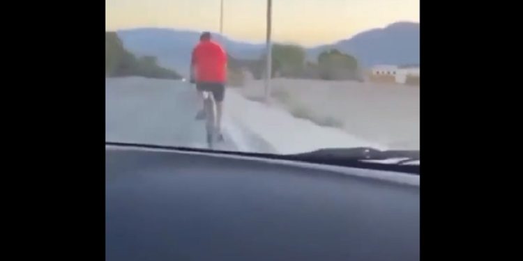 A bicyclist is seen from the vehicle that hit him from behind on Aug. 14.