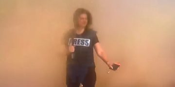 CNN’s Erin Burnett gets a faceful of sand from passing Israeli tanks.