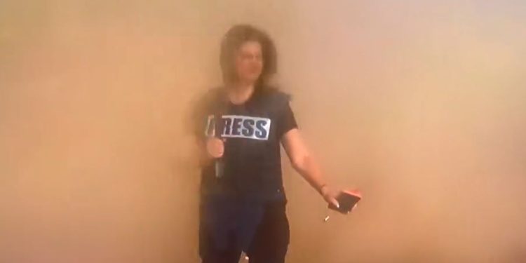 CNN’s Erin Burnett gets a faceful of sand from passing Israeli tanks.