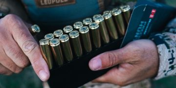 A man holds Hornady ammo.