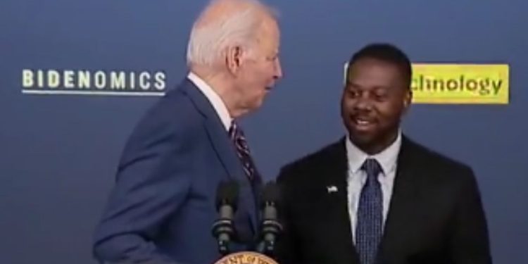 On Monday, Mark Anthony Thomas, right, was supposed to introduce President Joe Biden, left, before his speech, but Biden came out and started speaking before realizing his mistake.