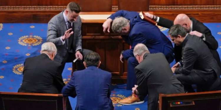 Newly elected Speaker of the House Mike Johnson joined other congressmen for a prayer on the House floor in January.