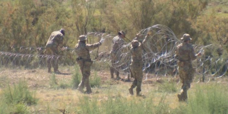 Texas National Guard troops erect razor-wire barriers near the state border with New Mexico.