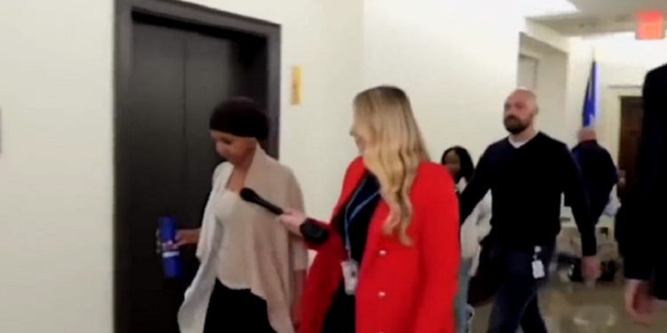 U.S. Rep. Ilhan Omar is questioned in a Capitol HIll hallway by Fox Business reporter Hillary Vaughn.
