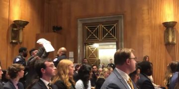 A protester is removed during the Senate Foreign Relations Committee nomination hearing.
