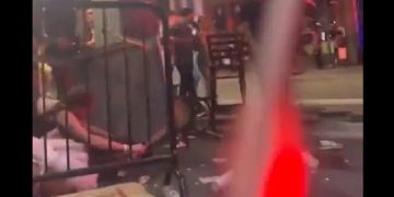 Halloween revelers scramble for cover after Sunday morning's shooting in the Ybor City nightlift district of Tampa, Florida.