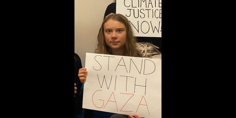 This Twitter screen shot shows climate activist Greta Thunberg holding a pro-Palestinian sign in a social media post.