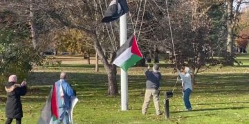 The Palestinian flag is raised below the POW-MIA flag and the American flag (not pictured) in North Andover, Massachusetts, on Tuesday.