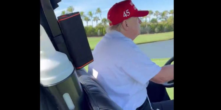 Donald Trump driving a golf cart