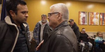 GOP presidential candidate Vivek Ramaswamy (left) speaks with Mike Wyatt, who identified himself as a former FBI agent and warned Ramaswamy to be "very careful" after the candidate called for the FBI to be shut down, and its duties transferred to other agencies in the federal government.