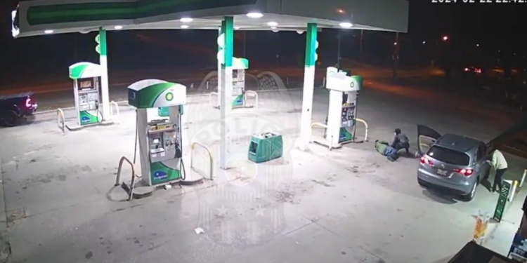 According to Kansas City police, surveillance video at a gas station last month shows a suspect going through the pockets of a man who was lying injured after being shot. The suspect was "looking for valuables,” police said.